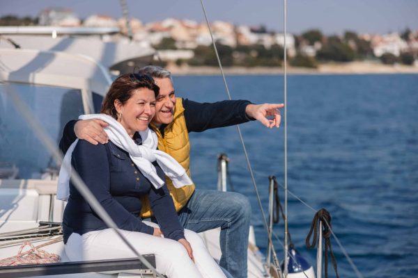 A loving mature couple looking at the view and enjoying their boat trip.